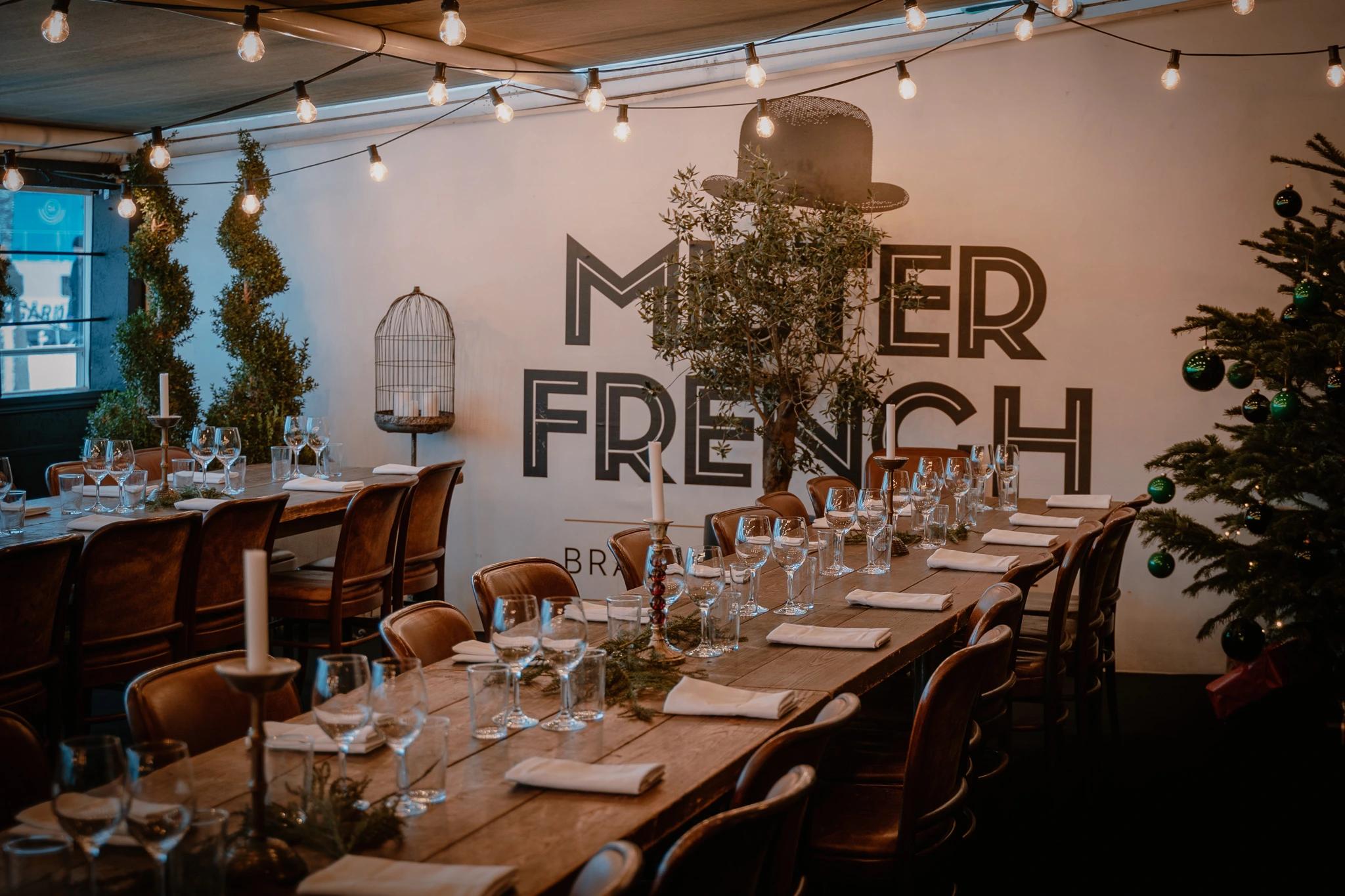 Table with chairs and a window and a Mister French sign