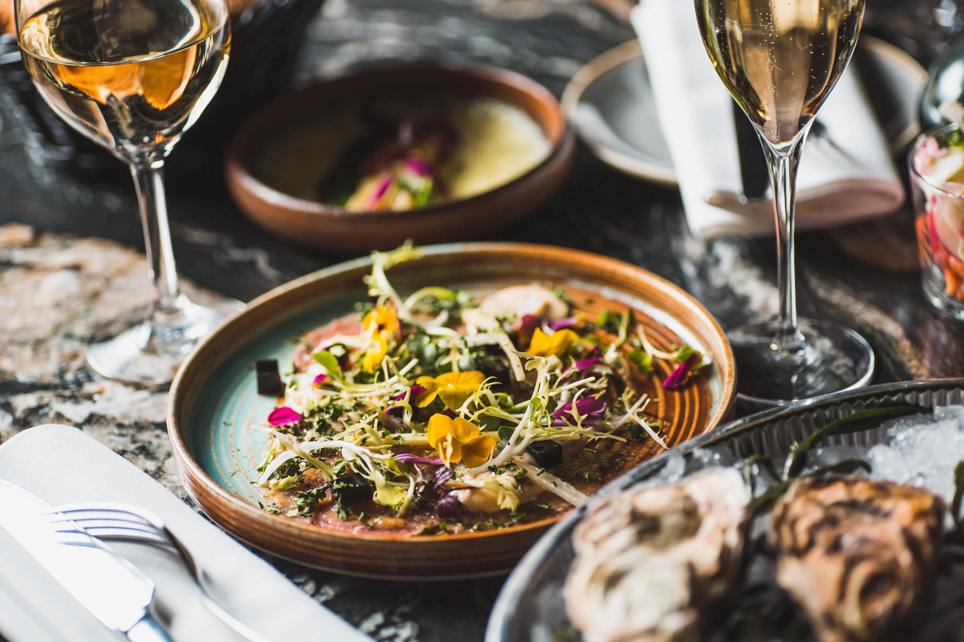 Plate with salad and two wine glasses